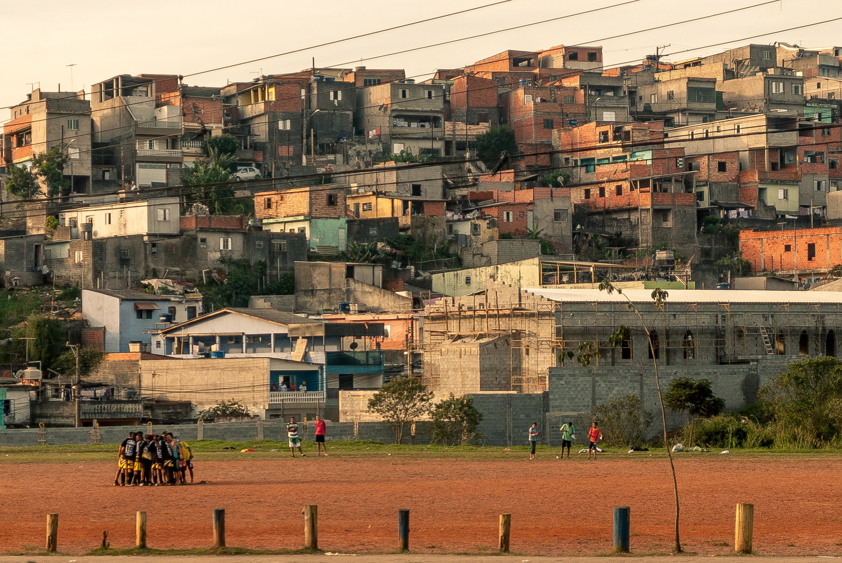 files/people-huddled-together-on-a-rust-colored-field.jpg